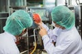 Quality control and food safety staff team inspection products contaminate standard in the food and drink factory production line Royalty Free Stock Photo