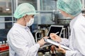 Quality control and food safety team inspection the product standard in the food and drink factory production line Royalty Free Stock Photo