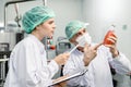 Quality control and food safety team inspection the product standard in the food and drink factory production line Royalty Free Stock Photo