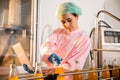 Quality inspector a woman carefully examines beverage bottles on a conveyor