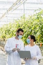 quality inspectors in medical masks holding