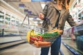 With that quality its no wonder she shops here. a woman holding a basket while shopping at a grocery store. Royalty Free Stock Photo