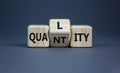 Quality over quantity symbol. Turned cubes and changed the word `quantity` to `quality`. Beautiful grey table, grey background