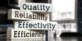 Quality, reliability, effectivity, efficiency - words on wooden blocks