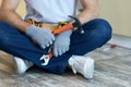 Quality repair. Cropped shot of young repairman holding a hammer and an adjustable wrench in his hands while sitting on Royalty Free Stock Photo