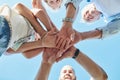 Quality time builds family ties. Low angle shot of a happy family joining their hands together outdoors.