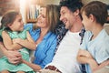 Quality time strengthens family ties. a happy family relaxing on the sofa together at home.