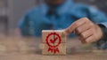 Quality warranty concept. Man hand puts the wooden cubes with quality warranty icon on wooden cubes. Used for banner and Royalty Free Stock Photo