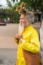 Quang Ninh, Vietnam - Mar 22, 2015: Portrait of old Vietnamese man with very long hair. He`s wearing Buddhist clothes