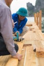 Quang Ninh, Vietnam - Mar 22, 2015: Vietnamese worker make wooden boat in Bai Tu Long bay, Ha Long city