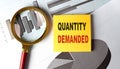 QUANTITY DEMANDED text on sticky on chart, business Royalty Free Stock Photo
