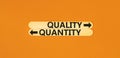 Quantity or quality symbol. Concept word Quantity or Quality on beautiful wooden stick. Beautiful orange table orange background.