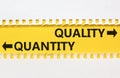 Quantity or quality symbol. Concept word Quantity or Quality on beautiful yellow paper. Beautiful white paper background. Business