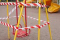 Quarantine concept. Empty playground is closed for quarantine Covid-19. Playground is blocked by red warning tape. Stay home Royalty Free Stock Photo