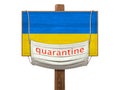 Quarantine during the COVID-19 coronavirus pandemic in Ukraine. Medical mask with the inscription Quarantine hangs on a sign with