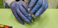 Quarantine covid-19 manicure women`s problem. seller with torn gloves . nails torn gloves.