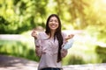 Quarantine Is Over. Happy asian girl removing mask outdoors and celebrating victory Royalty Free Stock Photo