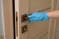 quarantine safety. Woman in the gloves opening a door Royalty Free Stock Photo