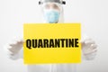 Quarantine, yellow warning sign with text Quarantine in doctor hands. Coronavirus covid-19 protection. Doctor in protective