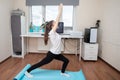 Quarantine yoga classes. Girl does online exercises by video calling