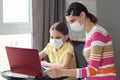 Quarantined girl and girl perform school tasks online Royalty Free Stock Photo