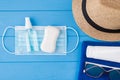 Quarantined summertime concept. Top above overhead view close-up photo of towel sunglasses sunscreen mask sanitizer sopa and Royalty Free Stock Photo