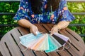 Quarantined woman choose colorful surgical masks to wear to prevent the spread of the CoronavirusCovid-19 Beautiful multi