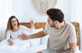 Quarrel in bed. Young couple passionately finds out relationship