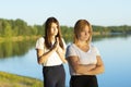 Quarrel of two close friends on a walk near the river, misunderstanding. A young woman is offended and does not want a dialogue,