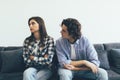 Quarreled young couple sitting on the sofa in their living room Royalty Free Stock Photo