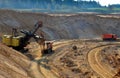 Quarry excavator loading sand or into dump truck at opencast. Excavation of mineral resources, the work of special mining Royalty Free Stock Photo