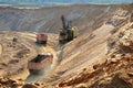 Quarry excavator loading sand or into dump truck at opencast Royalty Free Stock Photo