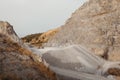 Quarry machines and piles of gravel over blue sky. Stone crushing and screening plant Royalty Free Stock Photo