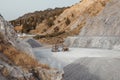 Quarry machines and piles of gravel over blue sky. Stone crushing and screening plant Royalty Free Stock Photo