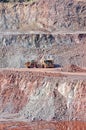 Quarry mine of porphyry rock. earthmover loading a dumper truck