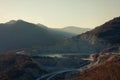 Quarry open pit for mining gravel at sunset in the mountains. Mining industry concept