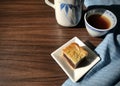 Quarter of moon cake in a dish, served with tea on blue cloth wooden background. with dramatic morning scene. Royalty Free Stock Photo