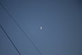 Quarter moon with electric wires at the left