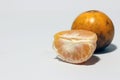 Quarter of peeled orange and one orange does not peel isolated on white background. Royalty Free Stock Photo