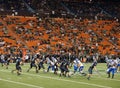 Quarterback sets to throw ball as other players scrabble for position