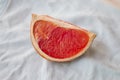 Quarters flat layout of grapefruit slices on marble and blue loaf close-up, top view with copy space Royalty Free Stock Photo