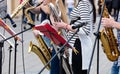 quartet of young musicians playing saxes during outdoor performance