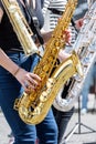 quartet of young musicians playing saxes during street performance