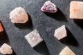 Quartz crystal pyramid and gem stones on slate