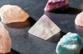 Quartz crystal pyramid and gem stones on slate Royalty Free Stock Photo