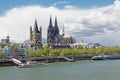 Quay along river Rhine with towers of the Cathedral and great Saint martin church and medieval housesin Cologne,