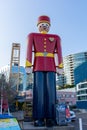 On the Quay, a Statue of the world`s tallest tin solder along the boardwalk in the evening summer sun