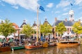 People and historic boats in old harbour during event Admiralty Days, Dokkum, Friesland, Netherlands