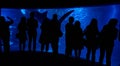 Quebec, Canada, April 16, 2019: Silhouetted people watching fish through aquarium glass tank