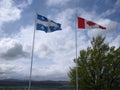 Quebec and Canada Flags Waving in the Wind Royalty Free Stock Photo